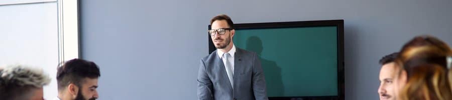Project manager presenting to a sponsor and team in a conference room